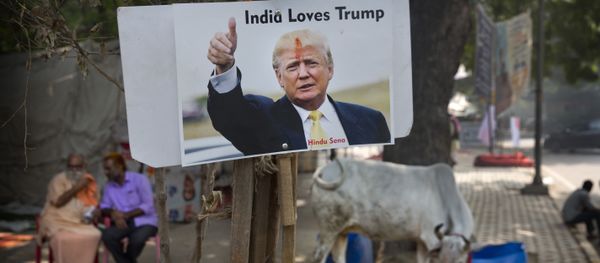A photograph of U.S. presidential candidate Donald Trump is displayed by activists belonging to 'Hindu Sena' or Hindu Army, a local organization in anticipation of his victory in New Delhi, India, Wednesday, Nov. 9, 2016 - Sputnik International