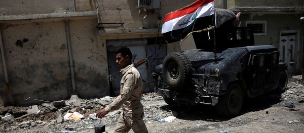 A member of the Iraqi Army's 9th Armoured Division walks past an armoured vehicle at the frontline in western Mosul, Iraq June 12, 2017 A member of the Iraqi Army's 9th Armoured Division walks past an armoured vehicle at the frontline in western Mosul, Iraq June 12, 2017 - Sputnik International