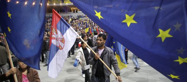 Supporter of Pro-Western former Serbian President and presidential candidate Boris Tadic waves with Serbian , center, and EU flags during a final pre-election rally in Belgrade, Serbia, Thursday, May 17, 2012. - Sputnik International