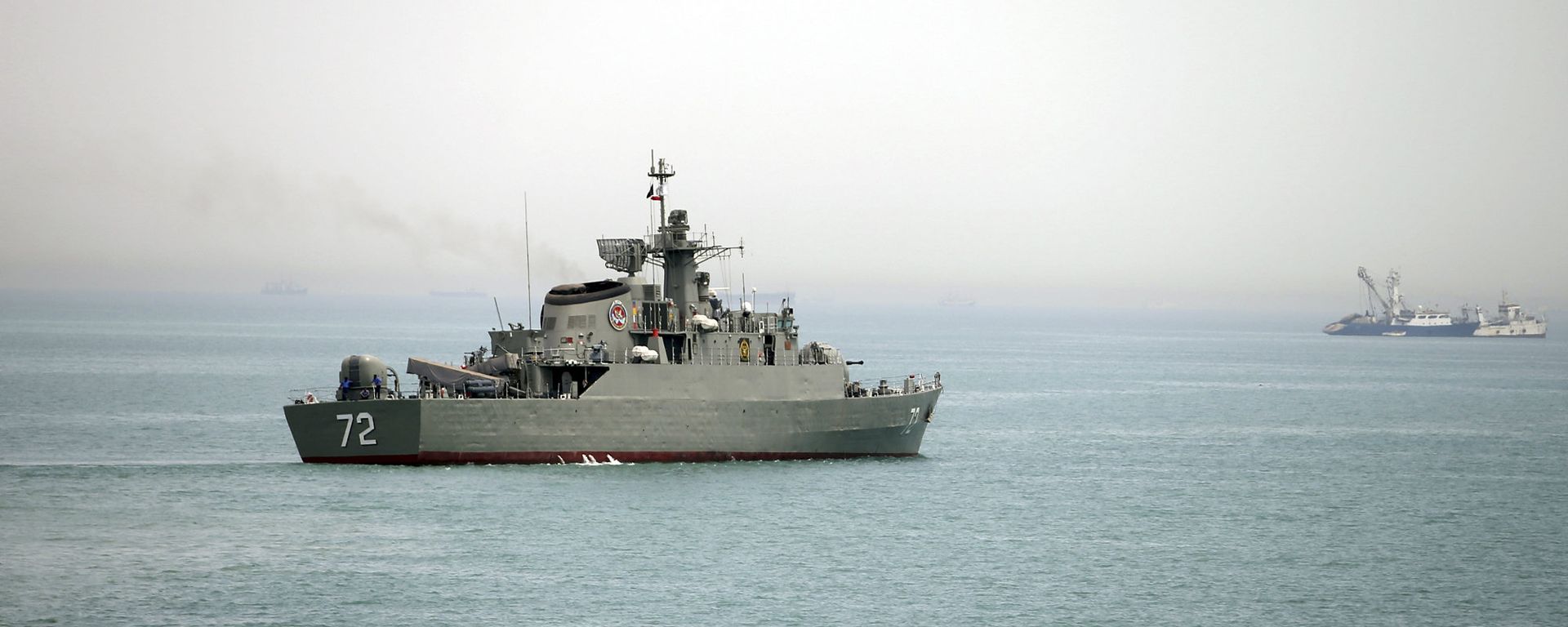 In this Tuesday, April 7, 2015, file photo released by the semi-official Fars News Agency, Iranian warship Alborz, foreground, prepares before leaving Iran's waters, at the Strait of Hormuz - Sputnik International, 1920, 28.07.2026