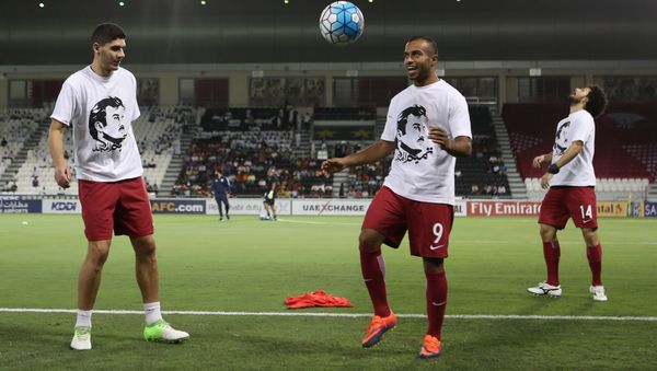 Qatar's national team players wear t-shirts bearing portraits of Emir Sheikh Tamim bin Hamad Al-Thani, in support the Qatari leader in the ongoing diplomatic crisis surrounding Qatar and other Gulf countries as they warm up prior to their World Cup 2018 Asia qualifying football match between Qatar and South Korea at the Jassim Bin Hamad stadium in Doha on June 13, 2017. - Sputnik International