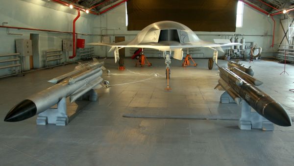 A full-sized model of the unmanned aerial vehicle Skat (background) and Kh-31 guided missiles (foreground) in a hangar of the Russian Aircraft Corporation MiG, the 8th MAKS-2007 air show in Zhukovsky - Sputnik International