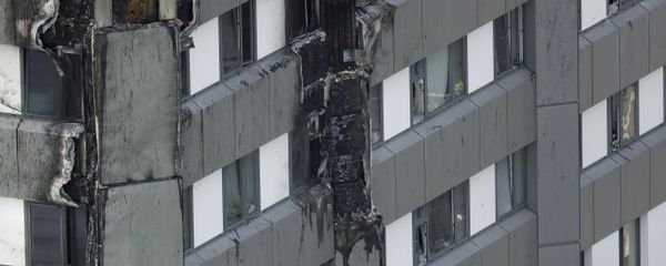 Fire damaged cladding is seen on the lower floors of the fire-gutted Grenfell Tower in London, Friday, June 16, 2017, after a fire engulfed the 24-story building Wednesday morning Fire damaged cladding is seen on the lower floors of the fire-gutted Grenfell Tower in London, Friday, June 16, 2017, after a fire engulfed the 24-story building Wednesday morning - Sputnik International