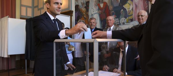 French President Emmanuel Macron casts his ballot as he votes at a polling station in Le Touquet, northern France, during the second round of the French parliamentary elections (elections legislatives in French) - Sputnik International