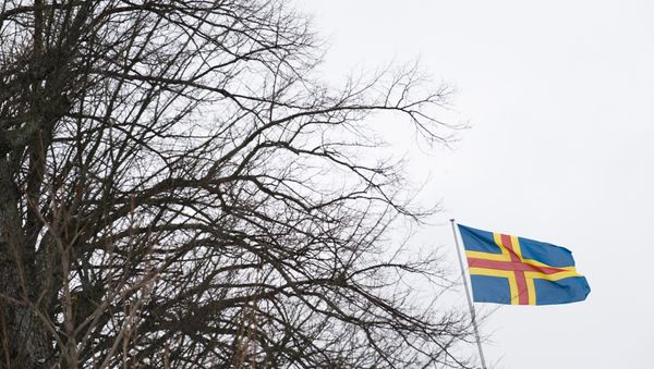 Flag of the southwestern Finnish Aaland Islands of the Baltic Sea flying in Mariehamn. (File) Flag of the southwestern Finnish Aaland Islands of the Baltic Sea flying in Mariehamn. (File) - Sputnik International