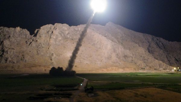 In this picture released by the Iranian state-run IRIB News Agency on Monday, June 19, 2017, a missile is fired from city of Kermanshah in western Iran targeting the Islamic State group in Syria - Sputnik International