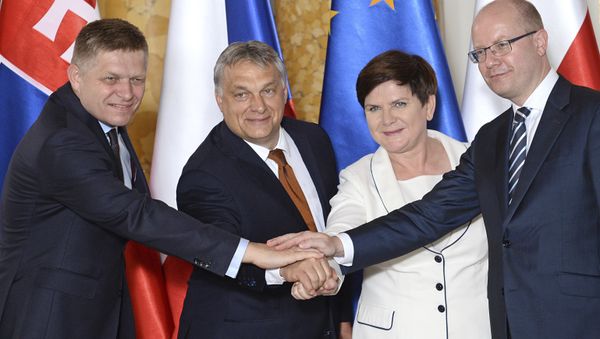 Prime Ministers of the four central European countries of the so-called Visegrad Group, Slovakia's Robert Fico, left, Hungary's Viktor Orban, second left, Poland's Beata Szydlo and Czech's Republic's Bohuslav Sobotka, right, shake hands during a ceremony of transferring the presidency of the Visegrad Group from Poland to Hungary, at the Royal Castle in Warsaw, Poland, Monday, June 19, 2017 Prime Ministers of the four central European countries of the so-called Visegrad Group, Slovakia's Robert Fico, left, Hungary's Viktor Orban, second left, Poland's Beata Szydlo and Czech's Republic's Bohuslav Sobotka, right, shake hands during a ceremony of transferring the presidency of the Visegrad Group from Poland to Hungary, at the Royal Castle in Warsaw, Poland, Monday, June 19, 2017 - Sputnik International