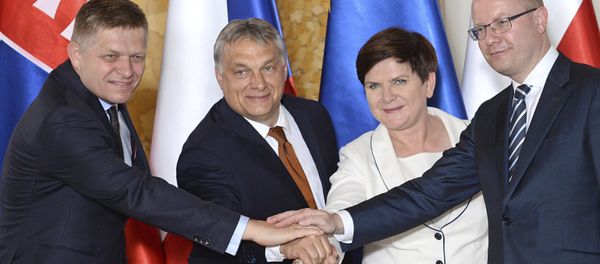 Prime Ministers of the four central European countries of the so-called Visegrad Group, Slovakia's Robert Fico, left, Hungary's Viktor Orban, second left, Poland's Beata Szydlo and Czech's Republic's Bohuslav Sobotka, right, shake hands during a ceremony of transferring the presidency of the Visegrad Group from Poland to Hungary, at the Royal Castle in Warsaw, Poland, Monday, June 19, 2017 Prime Ministers of the four central European countries of the so-called Visegrad Group, Slovakia's Robert Fico, left, Hungary's Viktor Orban, second left, Poland's Beata Szydlo and Czech's Republic's Bohuslav Sobotka, right, shake hands during a ceremony of transferring the presidency of the Visegrad Group from Poland to Hungary, at the Royal Castle in Warsaw, Poland, Monday, June 19, 2017 - Sputnik International