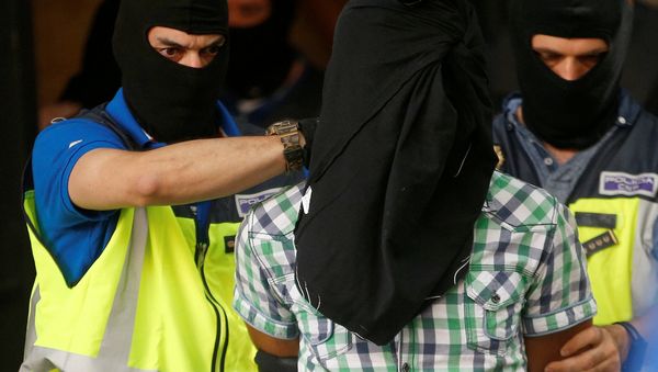 Police lead away a suspect from an apartment block during a raid in which they arrested a 32-year-old Moroccan they said was highly radicalised, in Madrid, Spain June 21, 2017 Police lead away a suspect from an apartment block during a raid in which they arrested a 32-year-old Moroccan they said was highly radicalised, in Madrid, Spain June 21, 2017 - Sputnik International