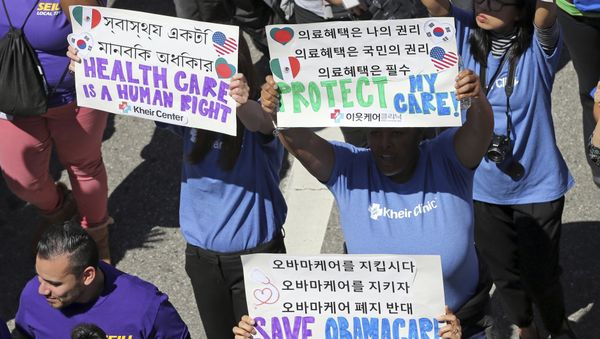 Hundreds of people march through downtown Los Angeles protesting President Donald Trump's plan to dismantle the Affordable Care Act, his predecessor's signature health care law, Thursday, March 23, 2017 - Sputnik International