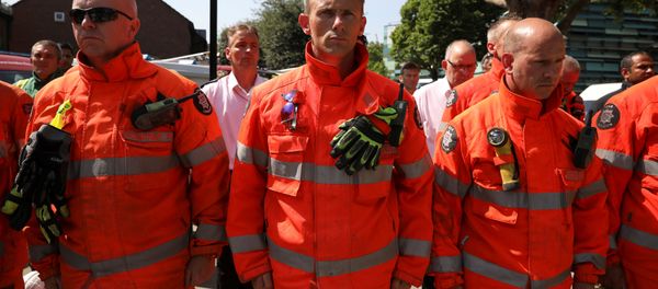 Members of the emergency services attend a minute's silence for the victims of the Grenfell Tower fire near the site of the blaze in North Kensington, London, Britain, June 19, 2017. Members of the emergency services attend a minute's silence for the victims of the Grenfell Tower fire near the site of the blaze in North Kensington, London, Britain, June 19, 2017. - Sputnik International