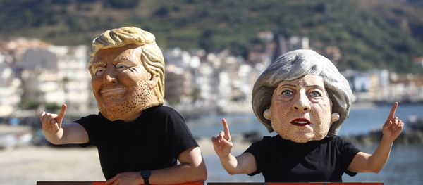 Protesters wear masks depicting U.S. President Donald Trump and Britain's Prime Minister Theresa May during a demonstration against a G7 summit organised by Oxfam in Giardini Naxos near Taormina, Sicily, Italy, May 27, 2017. - Sputnik International