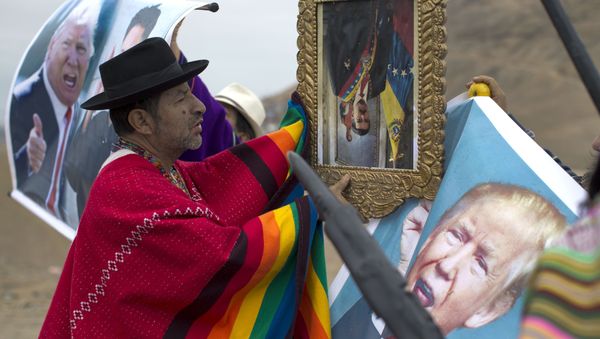A shaman performs a ceremony holding a portrait of Venezuela's President Nicolas Maduro upside down, as another holds a poster of U.S. President Donald Trump, on Morro Solar in Lima, Peru, Monday, June 12, 2017 A shaman performs a ceremony holding a portrait of Venezuela's President Nicolas Maduro upside down, as another holds a poster of U.S. President Donald Trump, on Morro Solar in Lima, Peru, Monday, June 12, 2017 - Sputnik International