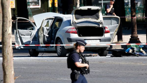 Police secure the area near a burned car at the scene of an incident in which it rammed a gendarmerie van on the Champs-Elysees Avenue in Paris, France, June 19, 2017 Police secure the area near a burned car at the scene of an incident in which it rammed a gendarmerie van on the Champs-Elysees Avenue in Paris, France, June 19, 2017 - Sputnik International