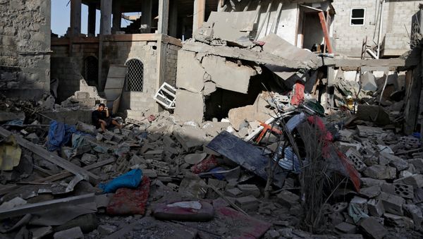 A man sits on the rubble of a house of his relatives, destroyed by a Saudi-led air strike in Sanaa, Yemen June 9, 2017 - Sputnik International
