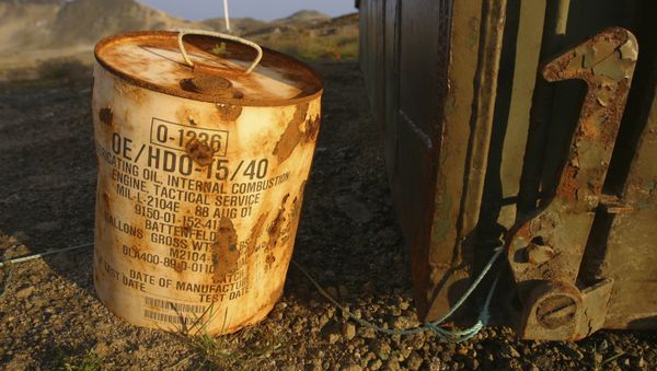 Rusty container of lubricant oil for a U.S. military vehicle stands among abandoned U.S. military material on Aug. 16, 2005, outside the eastern Greenland settlement of Kulusuk where there used to be an U.S. Air Force base as part of an early warning radar system (File) - Sputnik International