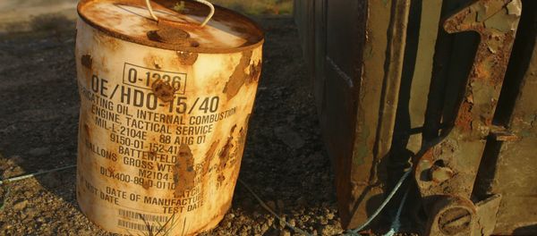 Rusty container of lubricant oil for a U.S. military vehicle stands among abandoned U.S. military material on Aug. 16, 2005, outside the eastern Greenland settlement of Kulusuk where there used to be an U.S. Air Force base as part of an early warning radar system (File) Rusty container of lubricant oil for a U.S. military vehicle stands among abandoned U.S. military material on Aug. 16, 2005, outside the eastern Greenland settlement of Kulusuk where there used to be an U.S. Air Force base as part of an early warning radar system (File) - Sputnik International