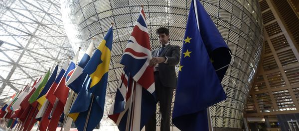 An organiser adjusts the British national flag on April 29, 2017, prior to the EU leaders summit at the Europa building, the main headquarters of European Council and the Council of the EU, in Brussels - Sputnik International