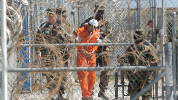 A detainee from Afghanistan is led by military police with his hands chained at Camp X-Ray at the U.S. Naval Base in Guantanamo Bay, Cuba, in this Feb. 2, 2002, file photo A detainee from Afghanistan is led by military police with his hands chained at Camp X-Ray at the U.S. Naval Base in Guantanamo Bay, Cuba, in this Feb. 2, 2002, file photo - Sputnik International