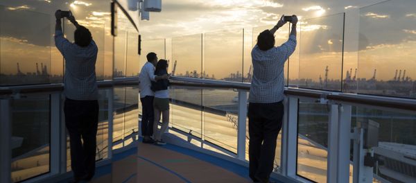 Passengers enjoy the sunset onboard Royal Caribbean's latest cruise ship the Ovation of the Seas ahead of its inaugural voyage at the International Cruise Terminal in northeastern China's Tianjin Municipality. (File) Passengers enjoy the sunset onboard Royal Caribbean's latest cruise ship the Ovation of the Seas ahead of its inaugural voyage at the International Cruise Terminal in northeastern China's Tianjin Municipality. (File) - Sputnik International