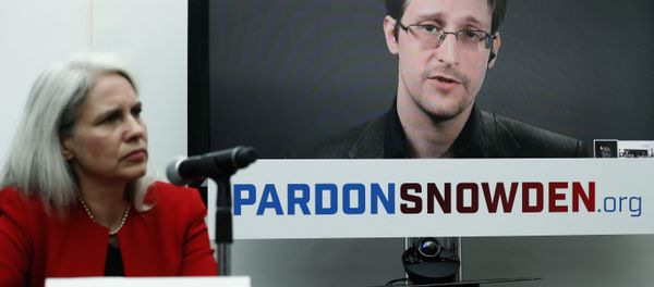 Dinah PoKempner, left, general council for Human Rights Watch, listens as Edward Snowden speaks on a television screen via video link from Moscow during a news conference to call upon President Barack Obama to pardon Snowden before he leaves office, Wednesday, Sept. 14, 2016, in New York.  - Sputnik International