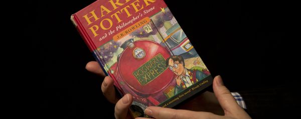 Sotheby's director of the department of printed books and manuscripts Dr Philip Errington poses for photographers with a first edition copy of the first Harry Potter book Harry Potter and the Philosopher's Stone containing annotations and illustrations by author J.K. Rowling, during a photocall organized for the media at the auction house's premises in London. (File) Sotheby's director of the department of printed books and manuscripts Dr Philip Errington poses for photographers with a first edition copy of the first Harry Potter book Harry Potter and the Philosopher's Stone containing annotations and illustrations by author J.K. Rowling, during a photocall organized for the media at the auction house's premises in London. (File) - Sputnik International