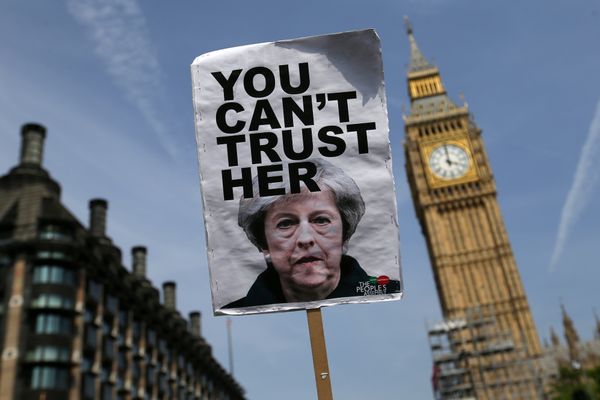 A placard showing a picture of Britain's Prime Minister Theresa May, saying You can't trust her is raised in front of the Elizabeth Tower, commonly referred to as Big Ben as protesters gather in Parliament Square after marching through central London on June 21, 2017. A placard showing a picture of Britain's Prime Minister Theresa May, saying You can't trust her is raised in front of the Elizabeth Tower, commonly referred to as Big Ben as protesters gather in Parliament Square after marching through central London on June 21, 2017. - Sputnik International