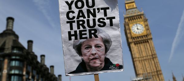 A placard showing a picture of Britain's Prime Minister Theresa May, saying You can't trust her is raised in front of the Elizabeth Tower, commonly referred to as Big Ben as protesters gather in Parliament Square after marching through central London on June 21, 2017. A placard showing a picture of Britain's Prime Minister Theresa May, saying You can't trust her is raised in front of the Elizabeth Tower, commonly referred to as Big Ben as protesters gather in Parliament Square after marching through central London on June 21, 2017. - Sputnik International