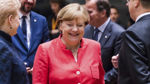 German Chancellor Angela Merkel, center, smiles as she attends a round table meeting at an EU Summit in Brussels on Friday, June 23, 2017. - Sputnik International