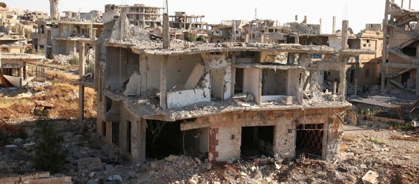 A rebel fighter walks past damaged buildings in a rebel-held part of the southern city of Deraa, Syria June 22, 2017 A rebel fighter walks past damaged buildings in a rebel-held part of the southern city of Deraa, Syria June 22, 2017 - Sputnik International