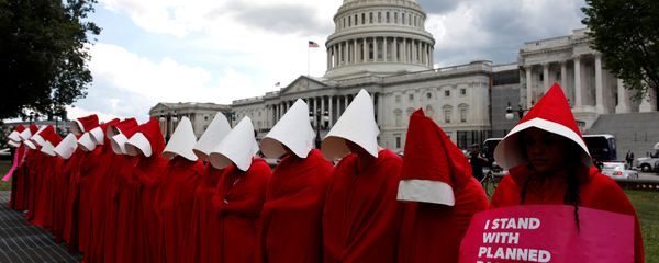 Women dressed as handmaids from the novel, film and television series The Handmaid's Tale demonstrate against cuts for Planned Parenthood in the Republican Senate healthcare bill at the U.S. Capitol in Washington, U.S., June 27, 2017 - Sputnik International