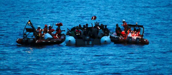 Migrants on a dinghy are rescued by Save the Children NGO crew from the ship Vos Hestia in the Mediterranean sea off Libya coast, June 17, 2017 - Sputnik International