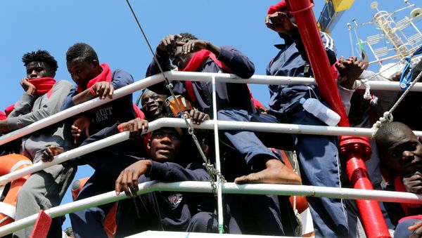 Migrants waits to disembark from the Vos Hestia ship as they arrives in the Crotone harbour, Italy, after being rescued by Save the Children crew in the Mediterranean sea off the Libya coast, June 21, 2017 Migrants waits to disembark from the Vos Hestia ship as they arrives in the Crotone harbour, Italy, after being rescued by Save the Children crew in the Mediterranean sea off the Libya coast, June 21, 2017 - Sputnik International