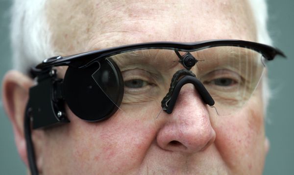 In this photo taken Saturday, Feb. 12, 2011,Eric Selby poses for a photograph with a sight camera fitted in a pair of glasses, which works in conjunction with an artificial retina implant called the Argus II fitted in his right eye, enabling him to detect light, in Coventry, England. In this photo taken Saturday, Feb. 12, 2011,Eric Selby poses for a photograph with a sight camera fitted in a pair of glasses, which works in conjunction with an artificial retina implant called the Argus II fitted in his right eye, enabling him to detect light, in Coventry, England. - Sputnik International
