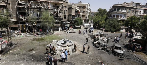 Syrians inspect the site of a suicide bomb attack in the capital Damascus' eastern Tahrir Square district, on July 2, 2017 - Sputnik International