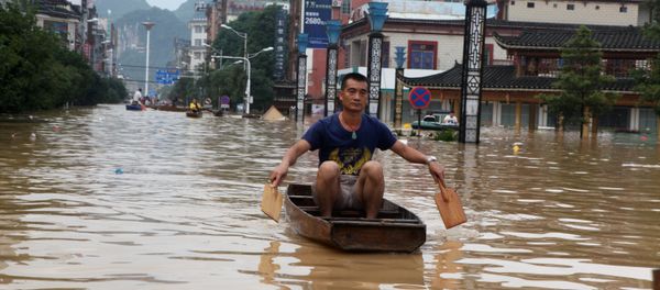 A man makes his way with a wooden boat through a flooded area in Liuzhou, Guangxi province, China July 2, 2017. - Sputnik International