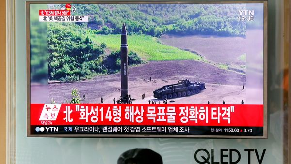 A man watches a TV broadcasting still photographs released by North Korea's state-run television KRT of North Korea's Hwasong-14 missile, a new intercontinental ballistic missile, which they said was successfully tested, at a railway station in Seoul, South Korea, July 4, 2017. A man watches a TV broadcasting still photographs released by North Korea's state-run television KRT of North Korea's Hwasong-14 missile, a new intercontinental ballistic missile, which they said was successfully tested, at a railway station in Seoul, South Korea, July 4, 2017. - Sputnik International