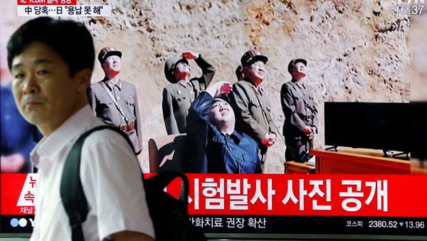 A man walks past a TV broadcasting still photographs released by North Korea's state-run television KRT of North Korea's Hwasong-14 missile, a new intercontinental ballistic missile, which they said was successfully tested, at a railway station in Seoul, South Korea, July 4, 2017. A man walks past a TV broadcasting still photographs released by North Korea's state-run television KRT of North Korea's Hwasong-14 missile, a new intercontinental ballistic missile, which they said was successfully tested, at a railway station in Seoul, South Korea, July 4, 2017. - Sputnik International