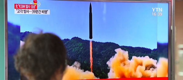 A woman walks past a television screen showing a picture of North Korea's launch of an intercontinental ballistic missile (ICBM), at a railway station in Seoul on July 4, 2017. A woman walks past a television screen showing a picture of North Korea's launch of an intercontinental ballistic missile (ICBM), at a railway station in Seoul on July 4, 2017. - Sputnik International