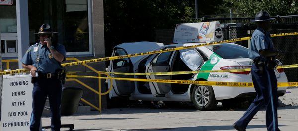 A Massachusetts State Police officer walks past the scene where a taxi cab crashed into a group of bystanders at the taxi pool at Logan International Airport in Boston, Massachusetts, U.S A Massachusetts State Police officer walks past the scene where a taxi cab crashed into a group of bystanders at the taxi pool at Logan International Airport in Boston, Massachusetts, U.S - Sputnik International