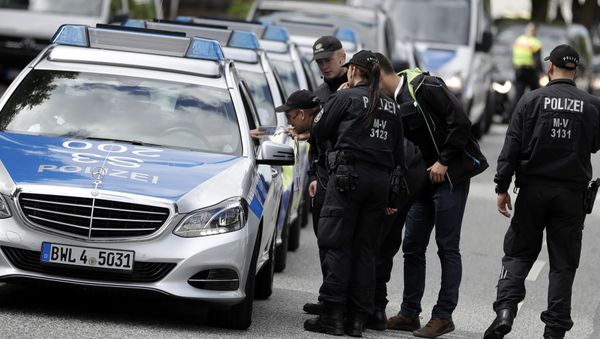 Police officers gather around the fair halls for the upcoming G-20 summit in Hamburg, Germany Police officers gather around the fair halls for the upcoming G-20 summit in Hamburg, Germany - Sputnik International