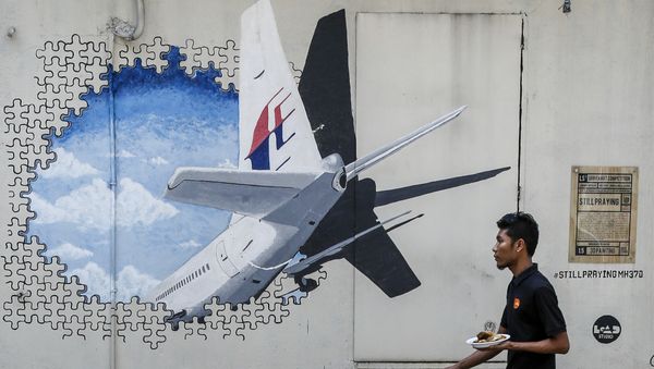 In this Tuesday, Feb. 23, 2016, file photo, a waiter walks past a mural of flight MH370 in Shah Alam outside Kuala Lumpur, Malaysia. In this Tuesday, Feb. 23, 2016, file photo, a waiter walks past a mural of flight MH370 in Shah Alam outside Kuala Lumpur, Malaysia. - Sputnik International