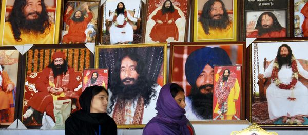 This file photo taken on December 14, 2014 shows Indian followers of deceased guru Ashutosh Maharaj sitting in front of posters bearing his image at a stall during a congregation at his ashram This file photo taken on December 14, 2014 shows Indian followers of deceased guru Ashutosh Maharaj sitting in front of posters bearing his image at a stall during a congregation at his ashram - Sputnik International