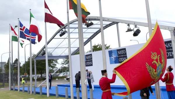 Soldiers from Montenegro unfurl the national flag during a ceremony to mark the accession of Montenegro at NATO Headquarters in Brussels on Wednesday, June 7, 2017 Soldiers from Montenegro unfurl the national flag during a ceremony to mark the accession of Montenegro at NATO Headquarters in Brussels on Wednesday, June 7, 2017 - Sputnik International
