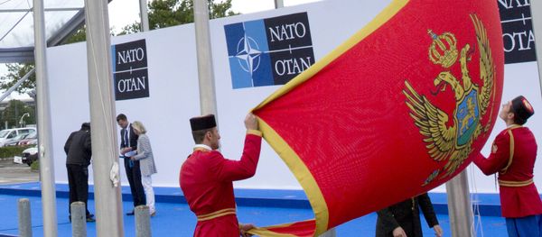 Soldiers from Montenegro unfurl the national flag during a ceremony to mark the accession of Montenegro at NATO Headquarters in Brussels on Wednesday, June 7, 2017 - Sputnik International