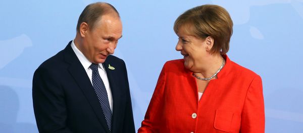 German Chancellor Angela Merkel greets Russian President Vladimir Putin as he arrives for the G20 leaders' summit in Hamburg, Germany July 7, 2017 (File photo). - Sputnik International