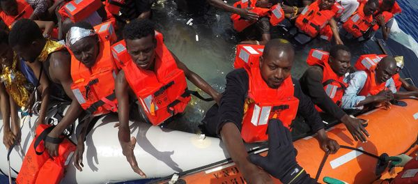 Migrants on a dinghy are rescued by Save the Children NGO crew from the ship Vos Hestia in the Mediterranean sea off Libya coast, June 17, 2017 - Sputnik International