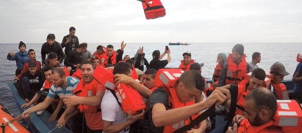 Migrants on wooden boat being rescued by Save the Children NGO crew from the ship Vos Hestia in the Mediterranean sea off Libya coast, June 18, 2017 Migrants on wooden boat being rescued by Save the Children NGO crew from the ship Vos Hestia in the Mediterranean sea off Libya coast, June 18, 2017 - Sputnik International