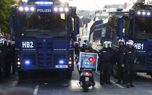 A food delivery driver tries to pass a riot police street blockade during the G20 summit in Hamburg, Germany, July 6, 2017 A food delivery driver tries to pass a riot police street blockade during the G20 summit in Hamburg, Germany, July 6, 2017 - Sputnik International