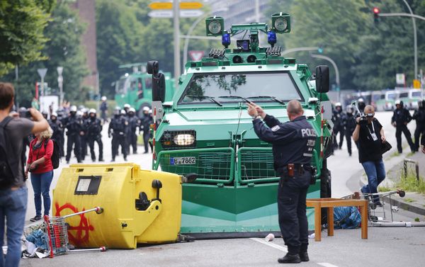 A German policeman stands in front of a barricade left by protesters in front of a police vehicle during the G20 summit in Hamburg, Germany, July 7, 2017 A German policeman stands in front of a barricade left by protesters in front of a police vehicle during the G20 summit in Hamburg, Germany, July 7, 2017 - Sputnik International